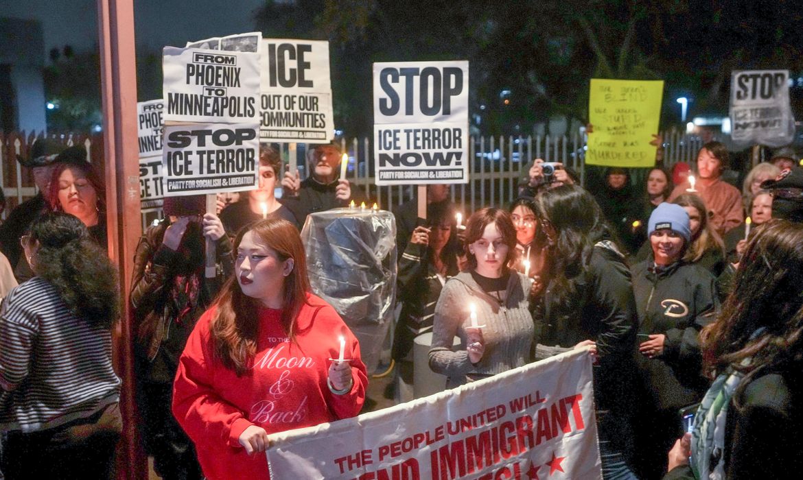 People gather outside the Phoenix ICE Field Office on Jan. 7, 2026, for a vigil in honor of Renee Nicole Good, who was shot and killed by an ICE agent in Minneapolis.