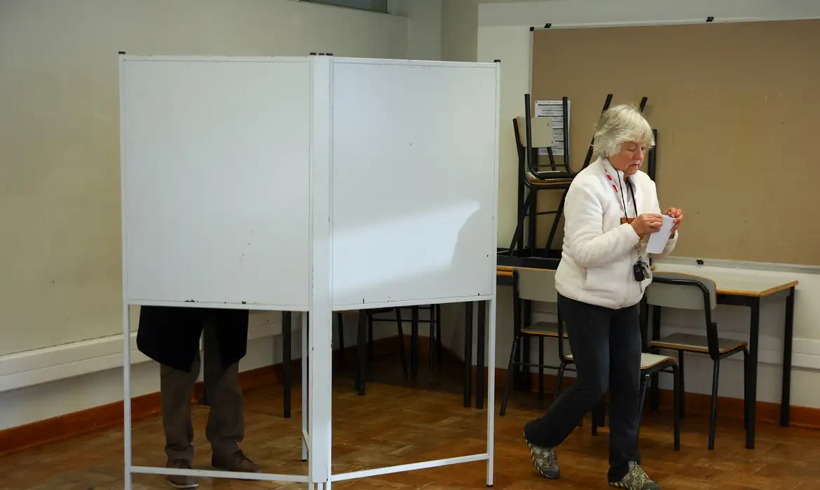 A woman walks from a voting booth during the presidential election in Lisbon, Portugal, January 18, 2026. REUTERS/Pedro Nunes