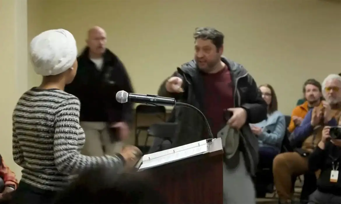 A man shouts at U.S. Representative Ilhan Omar (D-MN) after spraying her, during a town hall meeting days after a man identified as Alex Pretti was fatally shot by federal immigration agents trying to detain him, in Minneapolis, Minnesota, U.S., January 27, 2026, in a still image from video. REUTERS/Maria Alejandra Cardona