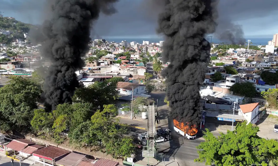 Smoke billows from burning vehicles amid a wave of violence, with torched vehicles and gunmen blocking highways in more than half a dozen states, following a military operation in which a government source said Mexican drug lord Nemesio Oseguera, known as