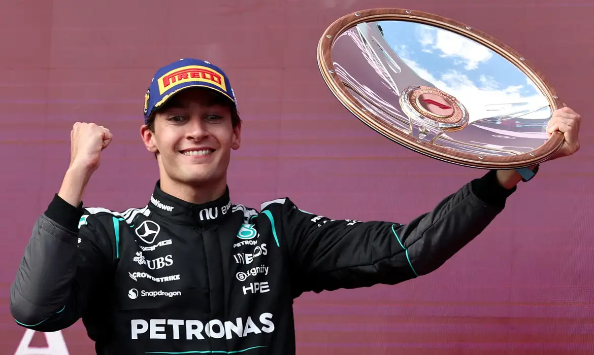 Formula One F1 - Australian Grand Prix - Albert Park Grand Prix Circuit, Melbourne, Australia - March 8, 2026 Mercedes' George Russell celebrates with the trophy on the podium after winning the Australian Grand Prix REUTERS/Mark Peterson     TPX IMAGES OF THE DAY