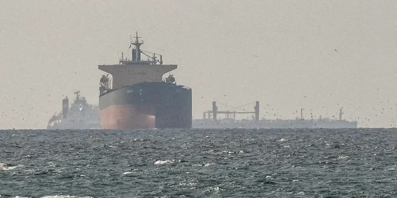FILE PHOTO: Cargo ships in the Gulf, near the Strait of Hormuz, as seen from northern Ras al-Khaimah, near the border with Oman’s Musandam governance, amid the U.S.-Israeli conflict with Iran, in United Arab Emirates, March 11, 2026. REUTERS/Stringer//File Photo