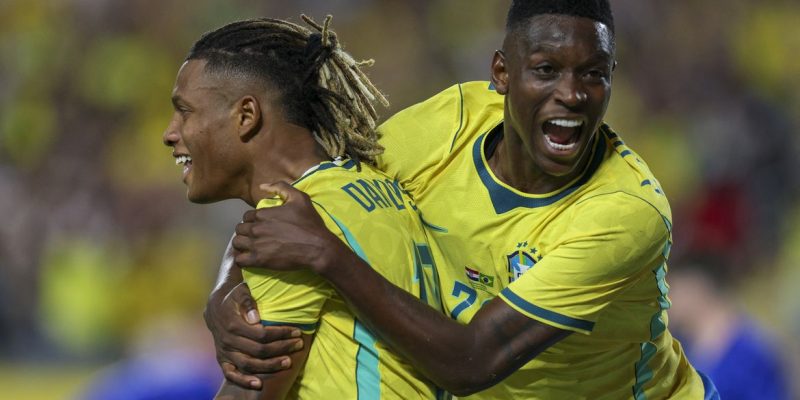 Mar 31, 2026; Orlando, Florida, USA; Brazil midfielder Danilo (18) reacts with forward Luiz Henrique (20) after scoring a goal against Croatia in the first half during an international friendly at Camping World Stadium. Mandatory Credit: Nathan Ray Seebeck-Imagn Images