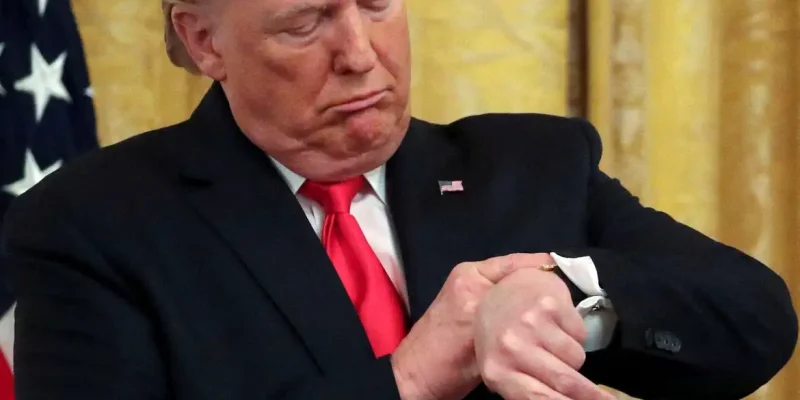 FILE PHOTO: U.S. President Donald Trump checks his watch during an event to celebrate federal judicial confirmations in the East Room of the White House in Washington, D.C., U.S., November 6, 2019. REUTERS/Jonathan Ernst/File Photo