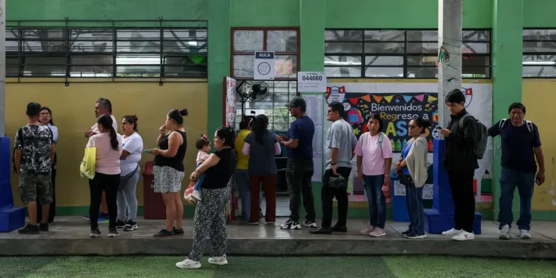 People queue to vote at a polling station after Peru's general election was extended to a second day in some precincts of the capital due to the late setup of voting tables and the absence of citizens assigned to receive voters, in Lima, Peru, April 13, 2026. REUTERS/Manuel Orbegozo
