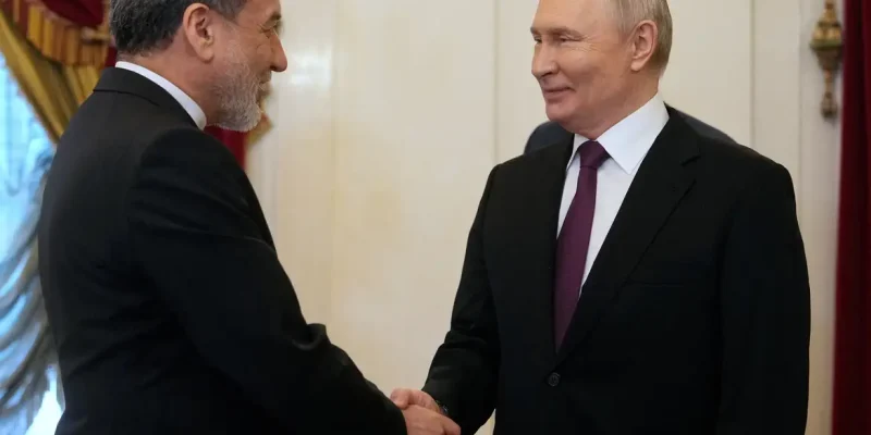 Russian President Vladimir Putin shakes hands with Iranian Foreign Minister Abbas Araqchi during a meeting at the Boris Yeltsin Presidential Library in Saint Petersburg, Russia April 27, 2026. Dmitri Lovetsky/Pool via REUTERS