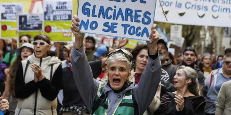 A woman marches toward the National Congress as lawmakers debate a reform to the Glaciers Law in Buenos Aires, Argentina, on April 8, 2026. The reform, promoted by Argentine President Javier Milei, seeks to allow provinces to define glacier protection zones to permit the expansion of mining activity. (Photo by Matias Baglietto/NurPhoto)NO USE FRANCE