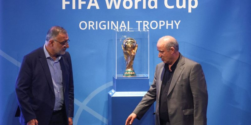 Presidente da Federação Iraniana de Futebol, Mehdi Taj, e o prefeito de Teerã, Alireza Zakani, ao lado do troféu da Copa do Mundo