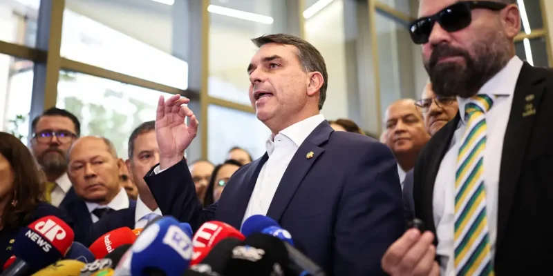 Flavio Bolsonaro speaks with members of the press after a meeting, following a scandal over messages tied to his request for funding for a biopic about former Brazilian President Jair Bolsonaro, from disgraced banker Daniel Vorcaro, who was arrested in March on suspicion of leading a multibillion-dollar fraud scheme, in Brasilia, Brazil, May 19, 2026. REUTERS/Mateus Bonomi