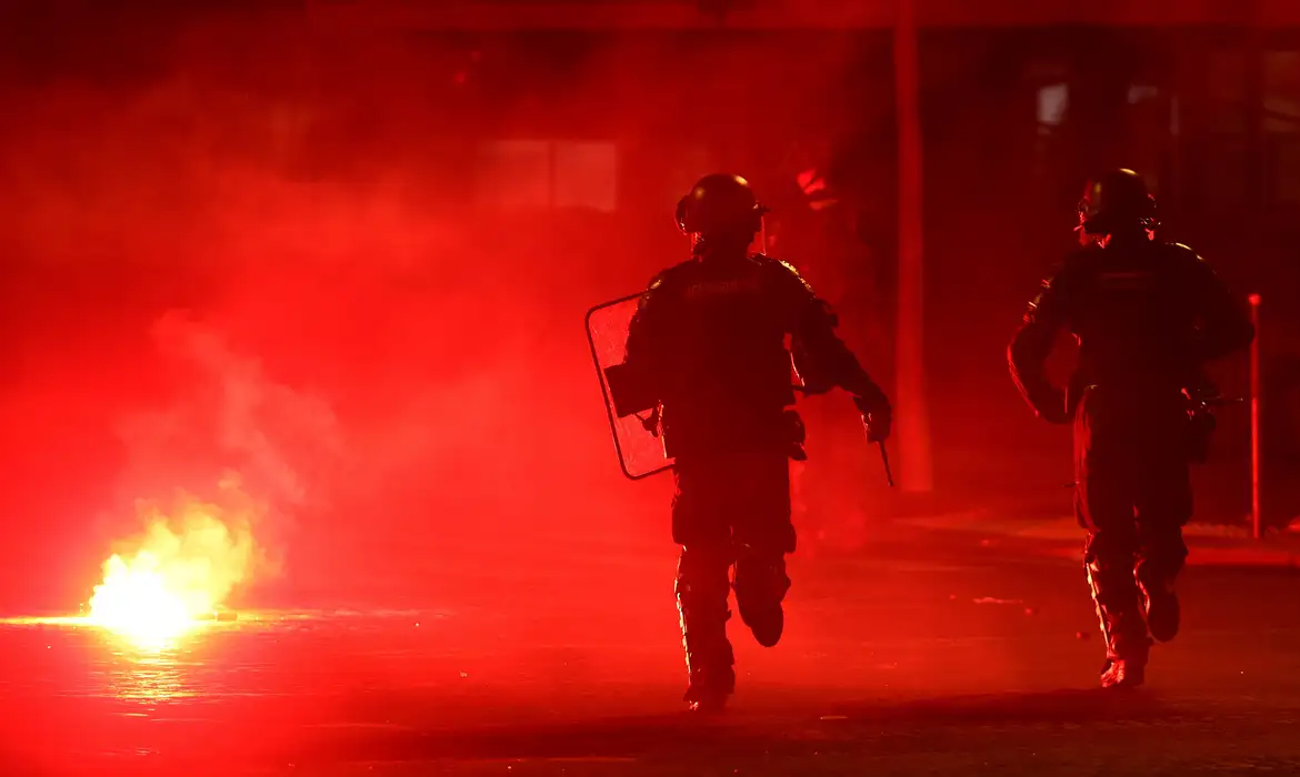 Policiais se protegem de sinalizador em meio a tumulto em Paris durante comemoração do título do Paris St Germain na Liga dos Campeões
31 de maio de 2026 REUTERS/Abdul Saboor