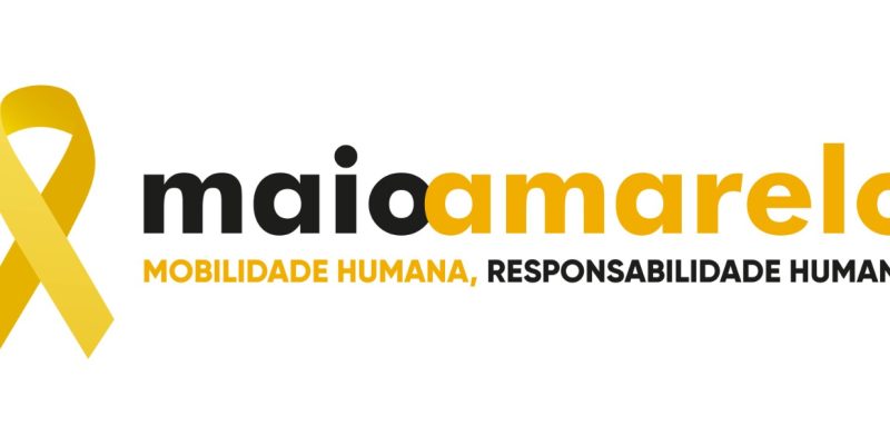 Logotipo da campanha Maio Amarelo composto por um laço amarelo à esquerda e o texto