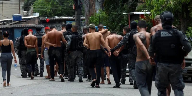 Members of the military police special unit detain suspected drug dealers during a police operation against drug trafficking at the favela do Penha, in Rio de Janeiro, Brazil October 28, 2025. REUTERS/Aline Massuca