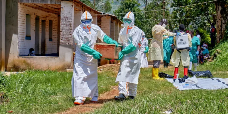 Red Cross workers wearing personal protective equipment (PPE) carry a coffin with the dead body of a child who died of Ebola, as aid agencies intensify efforts to contain a new Ebola outbreak involving the Bundibugyo strain in Mongbwalu, Djugu Territory, Ituri province, Democratic Republic of Congo, May 24, 2026. The child's parents remain at the isolation centre at the Mongbwalu General Referral Hospital. REUTERS/Gradel Muyisa Mumbere