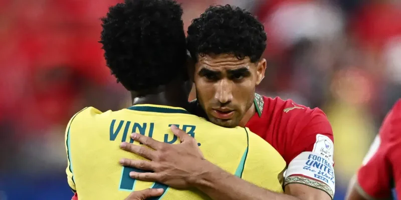 Soccer Football - FIFA World Cup 2026 - Group C - Brazil v Morocco - New York/New Jersey Stadium, East Rutherford, New Jersey, U.S. - June 13, 2026 Morocco's Achraf Hakimi embraces Brazil's Vinicius Junior after the match REUTERS/Dylan Martinez