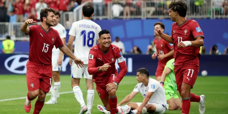 Soccer Football - FIFA World Cup 2026 - Group K - Portugal v Uzbekistan - Houston Stadium, Houston, Texas, U.S. - June 23, 2026 Portugal's Cristiano Ronaldo celebrates with Joao Felix and Joao Neves after Abduvohid Nematov scores an own goal and Portugal's fourth REUTERS/Phil Noble