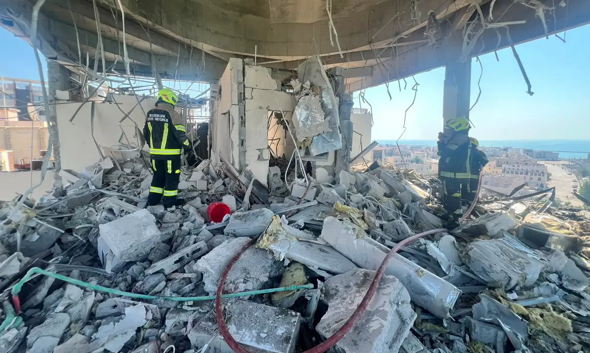 Bahrain civil defence and rescue personnel work in a residential building, which according to the Bahraini Interior Ministry, was hit by an Iranian drone, in Muharraq, Bahrain, June 28, 2026. Bahrain Police Media/Handout via REUTERS