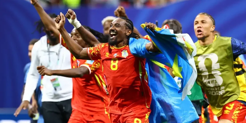 Soccer Football - FIFA World Cup 2026 - Group K - DR Congo v Uzbekistan - Atlanta Stadium, Atlanta, Georgia, U.S. - June 27, 2026 DR Congo's Samuel Moutoussamy celebrates with their national flag after the match as they qualify for the knockout stages of the World Cup REUTERS/Bernadett Szabo     TPX IMAGES OF THE DAY