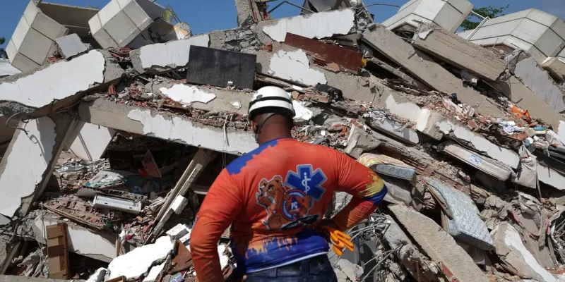 A member of Civil Protection looks at rubble of a collapsed building in the aftermath of the June 24 earthquakes in La Guaira, Venezuela, July 1, 2026. REUTERS/Ricardo Arduengo
