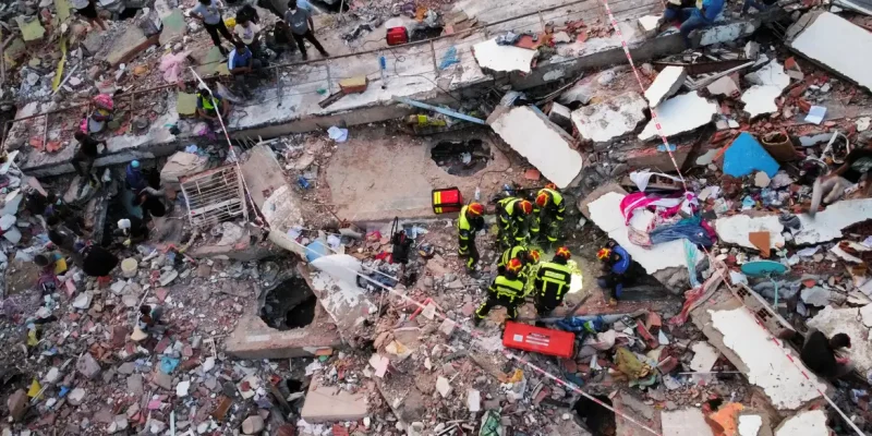 A drone view of members of a Slovakian rescue team taking part in rescue efforts at the site of a collapsed building in the Mision Vivienda government residential complex, in the aftermath of the June 24 earthquakes, in Los Cocos, in La Guaira state, Venezuela, July 1, 2026. REUTERS/Leonardo Fernandez Viloria