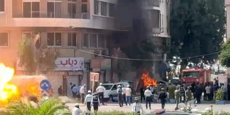 Emergency personnel work as smoke and fire rise at the site where explosive devices blew up near a hotel where French President Emmanuel Macron was meant to be staying, in Damascus, Syria, in this screengrab obtained from a video, July 7, 2026. REUTERS/Yamam Al Shaar        TPX IMAGES OF THE DAY