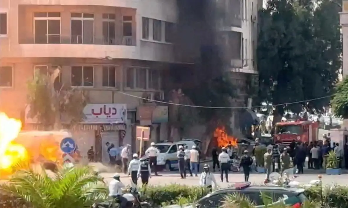 Emergency personnel work as smoke and fire rise at the site where explosive devices blew up near a hotel where French President Emmanuel Macron was meant to be staying, in Damascus, Syria, in this screengrab obtained from a video, July 7, 2026. REUTERS/Yamam Al Shaar        TPX IMAGES OF THE DAY