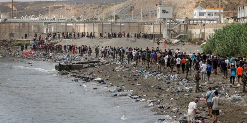 People walk towards the border with Morocco leaving Spain, amid mass crossings of migrants on foot and by sea from Morocco into Spanish territory, in Ceuta, Spain, July 31, 2026. REUTERS/Jon Nazca TPX IMAGES OF THE DAY