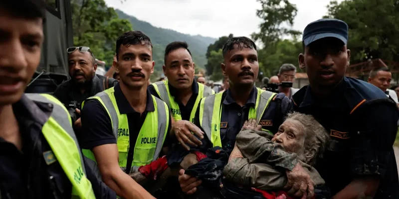 Police officers carry a survivor to a safer place following a flash flood at Trishuli in Nuwakot district, Nepal, August 26, 2026. REUTERS/Navesh Chitrakar REFILE - QUALITY REPEAT    TPX IMAGES OF THE DAY